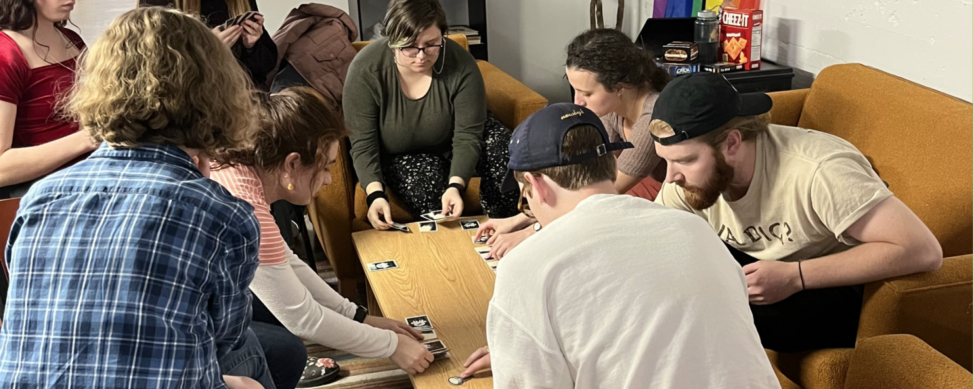 Residents playingcard games outside Saffron Café